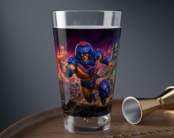 May include: A clear glass pint tumbler featuring a vibrant, full-colour graphic of a muscular, armoured character in a blue helmet and suit, holding a glowing orange weapon against a dark, fiery, and rocky background with purple and green accents.