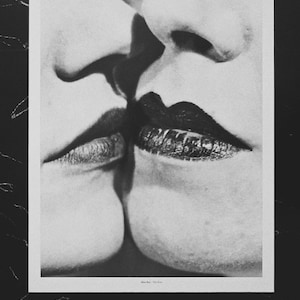 Man Ray &quot;Il Baccio, 1930&quot; 2001 monochrome art print. Copyright, title, and description on the reverse. Approx. 36.5 x 28.5 cm.