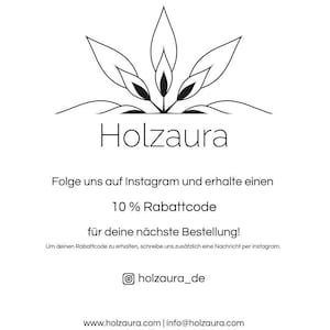 May include: Black and white illustration of a stylized plant with the text "Holzaura" below it. The text "Folge uns auf Instagram und erhalte einen 10% Rabattcode f&uuml;r deine n&auml;chste Bestellung!" is below the illustration. The text "Um deinen Rabattcode zu erhalten, schreibe uns zus&auml;tzlich eine Nachricht per Instagram." is below the discount code text. The text "holzaura_de" is below the previous text. The text "www.holzaura.com | info@holzaura.com" is below the Instagram handle.