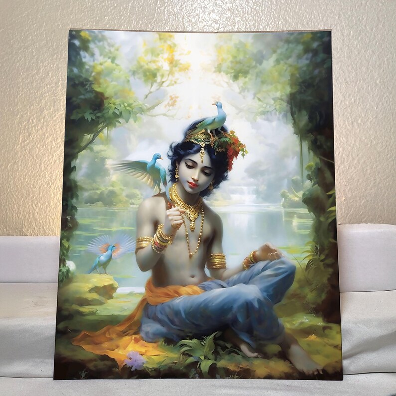 May include: A vibrant painting depicts a serene figure adorned with gold jewelry and a crown of flowers, seated amidst lush greenery. Two blue birds perch on the figure, with a waterfall and bright light in the background. The figure is wearing blue pants and an orange sash.
