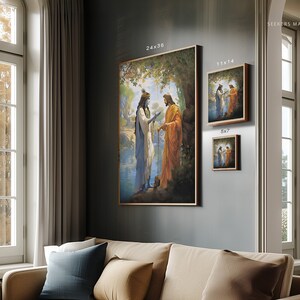 May include: A painting of two figures standing by a river. The figure on the left is wearing a blue robe and the figure on the right is wearing an orange robe. The painting is set in a forest with trees and foliage in the background.
