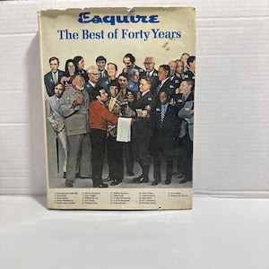 May include: A vintage copy of Esquire magazine, titled "The Best of Forty Years," features a group of men in suits and casual attire. The cover has a blue and white color scheme, with the magazine's title in a stylized font.