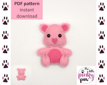 May include: PDF pattern for a pink felt pig toy. The pattern includes instructions for sewing the toy. The pattern is available for instant download. The image also shows a finished pig toy.