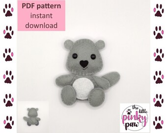 May include: PDF pattern for a gray felt koala toy. The pattern includes instructions for sewing the toy. The pattern is available for instant download. The image also shows a small gray felt koala toy.