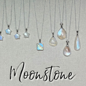 May include: A collection of moonstone necklaces with silver chains. The pendants vary in shape, including stars, squares, and teardrops. The word "Moonstone" is written in cursive script below the necklaces.