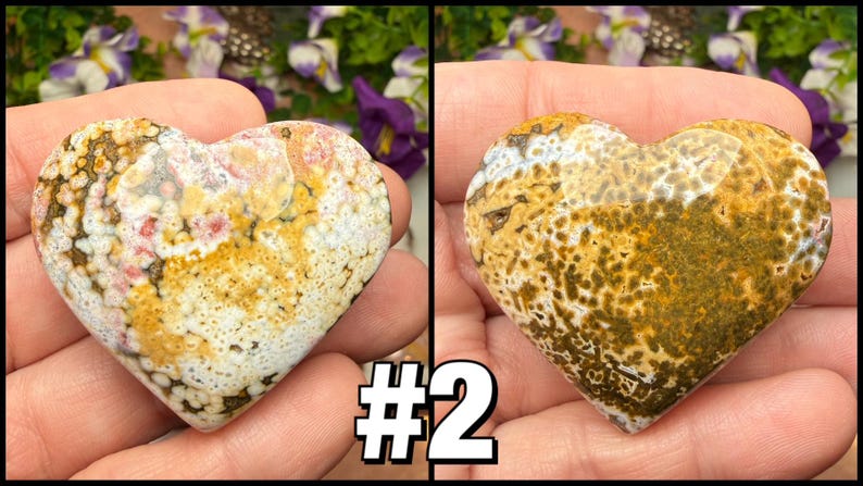 May include: Two heart-shaped stones with unique patterns. One features a mix of white, yellow, and pink hues, while the other displays a blend of yellow and brown. The stones are held in a hand, showcasing their natural beauty.