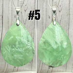 May include: Two green fluorite gemstone pendants with silver-coloured bails and chains. The teardrop-shaped stones have white veining. The number "#5" is printed in black on the image.