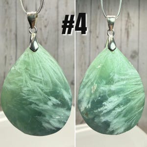 May include: A green gemstone pendant necklace with a teardrop shape and white veining. The pendant hangs from a silver chain. The number "#4" is displayed in black text in the upper right corner.