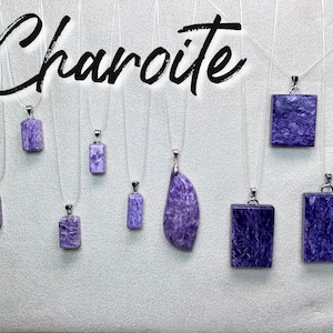 May include: A collection of nine silver necklaces with purple and white charoite stone pendants. The necklaces are displayed on a white background with the word "Charoite" written in black.
