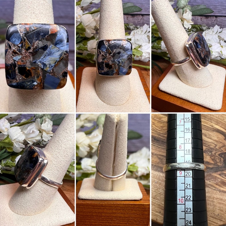 May include: A silver ring with a square-shaped blue, brown, and gold gemstone. The ring is on a white ring display stand. The ring size is 9.5.