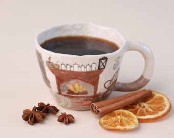 May include: A ceramic mug filled with dark liquid, featuring a hand-painted fireplace design with pumpkins and candles. Accompanying the mug are star anise, cinnamon sticks, and dried orange slices, creating a cozy, autumnal theme.