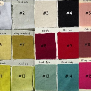 May include: A color chart with 15 fabric swatches, each labeled with a number and a Vietnamese word describing the color. The colors include white, black, pink, red, yellow, green, and blue.