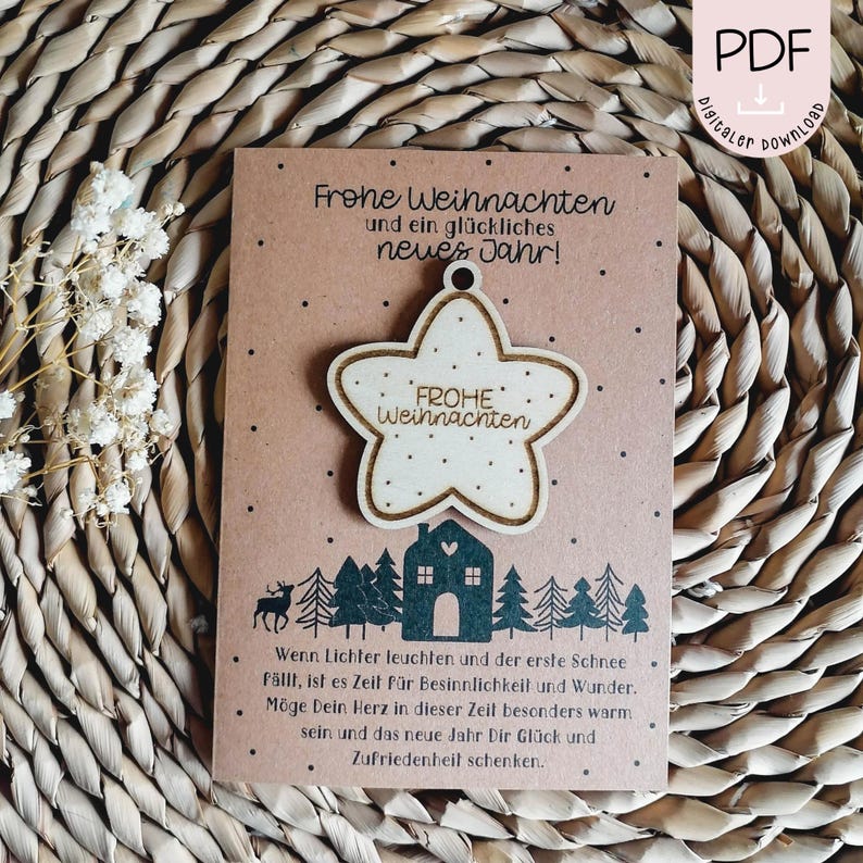 May include: A brown card with the text "Frohe Weihnachten und ein gl&uuml;ckliches neues Jahr!"  A wooden star ornament with the text "Frohe Weihnachten" is attached to the card. The card has a winter scene with a house and trees.