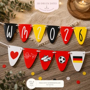 May include: A two-row bunting banner featuring triangular pennants in black, red, yellow, and white. The top row displays the text WM 2026. The bottom row features icons including a red heart, a beer mug, a sausage, soccer cleats, a ball, and a flag.