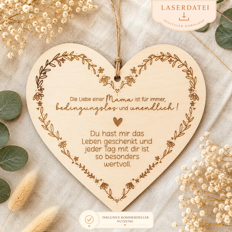 May include: A heart-shaped wooden plaque with a floral border and a jute string for hanging. The plaque features engraved text in German, including the words "Mama" and "Leben". The design is a light brown color.