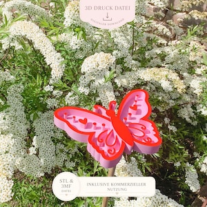 May include: A pink and red butterfly-shaped garden stake with heart cutouts. The stake is made of layered materials and is set against a backdrop of white flowers and greenery. Text on the image reads "3D DRUCK DATEI" and "DIGITALER DOWNLOAD".