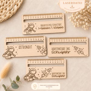 May include: Wooden rulers with engraved designs of astronauts and rockets. The rulers feature measurements up to 15 inches and include text such as "Astronaut" and "Galaktischer Schulstart, Mission 1. Klasse".