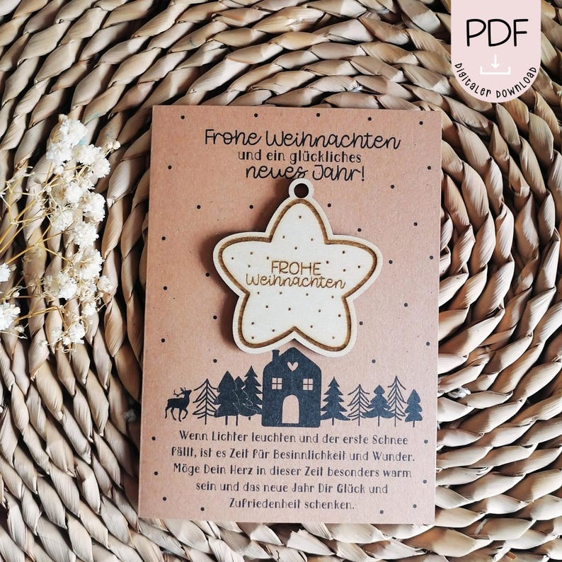 May include: A brown card with the text "Frohe Weihnachten und ein gl&uuml;ckliches neues Jahr!" and a wooden star ornament with the text "FROHE Weihnachten" on it. The card has a winter scene with a house and trees.