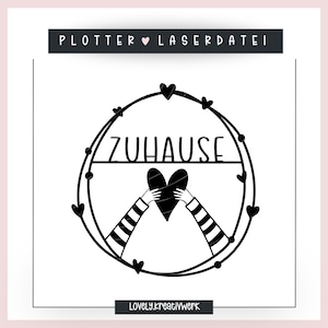 May include: Black and white graphic design with a heart and the word "ZUHAUSE" in a circle of hearts. The text "PLOTTER ♥ LASERDATEI" is at the top of the design and the text "LOVELY.kreativWerk" is at the bottom.