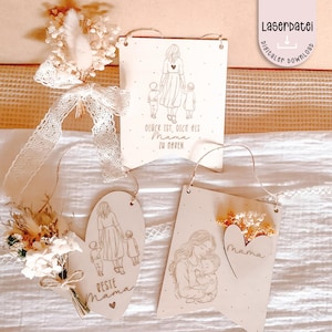 May include: Three wooden plaques with engraved illustrations and text. One shows a mother with two children and the text "Glück ist, dich als Mama zu haben." Another says "Beste Mama." The third shows a mother holding a baby, with the word "Mama."