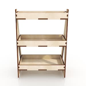 May include: A three-tier wooden shelf unit with brown trim. The shelves are made of light wood and are rectangular in shape.