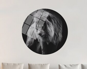 May include: A black and white photograph of a lion with a thick mane, printed on a round, clear acrylic disc.