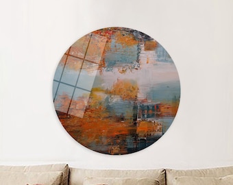 Puede incluir: Impresión de arte abstracto en un lienzo redondo con una mezcla de pintura naranja, marrón, azul y blanco. El lienzo está montado en una pared blanca.