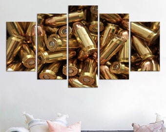 May include: A close-up of a large pile of gold-colored bullet casings. The casings are arranged in a random pattern, creating a visually interesting texture.