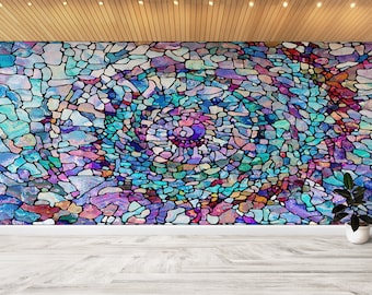 May include: Abstract stained glass style artwork with a swirling pattern of blue, purple, pink, and green colors. The artwork is framed in black and set against a white wall.