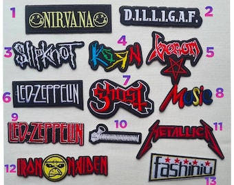 May include: A collection of thirteen embroidered fabric patches featuring various band logos and text designs including Nirvana, Slipknot, Led Zeppelin, Ghost, Metallica, Iron Maiden, and Fashiniu, each labeled with a pink number from one to thirteen.