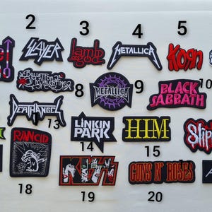 May include: A selection of embroidered patches displaying logos of rock bands such as "The Who," "Metallica," "Korn," "Black Sabbath," and "Guns N' Roses." The patches are in diverse colours and shapes, ideal for customising clothing.