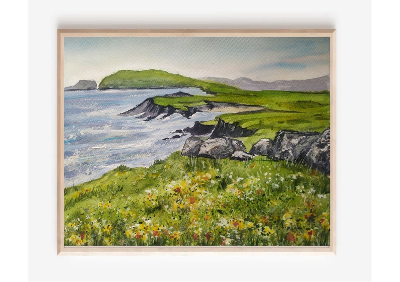 May include: A watercolor painting of a coastal landscape with a green hill, a rocky shoreline, and a blue ocean. The foreground features a field of wildflowers in shades of yellow, white, and red.