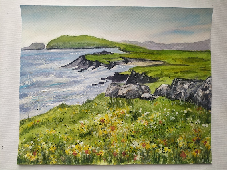 May include: Watercolor painting of a green grassy cliff overlooking a blue ocean with white waves. The cliff is covered in small yellow and white flowers.
