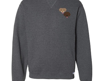 May include: A dark gray sweatshirt with two embroidered dog faces on the left chest. The dog faces are brown and light brown.