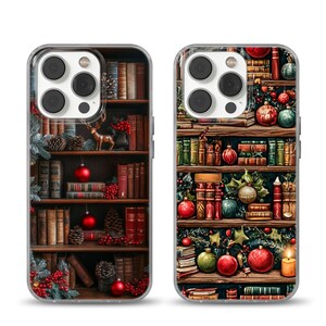 May include: Two phone cases with a festive bookshelf design. Each case features a detailed illustration of a wooden bookshelf filled with books, Christmas ornaments, pinecones, and a small deer figurine. The cases have a clear border.