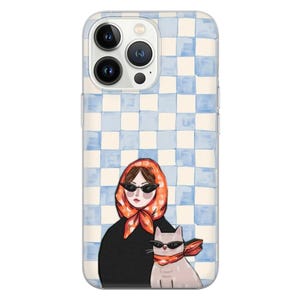May include: Clear phone case with a blue and white checkered pattern. The case features an illustration of a person wearing sunglasses and an orange scarf, with a cat also wearing sunglasses and a matching scarf.