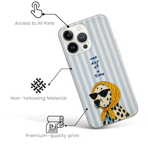 May include: A phone case with a light blue striped background and a cartoon Dalmatian wearing sunglasses and a yellow scarf. The case has the text "one day at a time". The case is designed to allow access to all ports and is made of non-yellowing material.