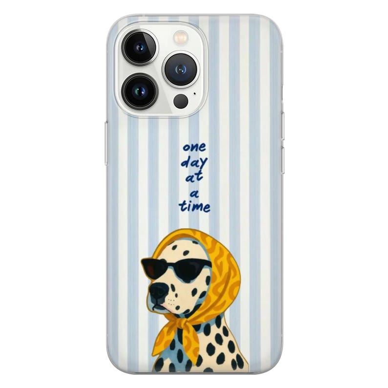 May include: A phone case with a light blue and white striped background. The case features a Dalmatian dog wearing sunglasses and a yellow scarf. The text "one day at a time" is written in blue cursive.