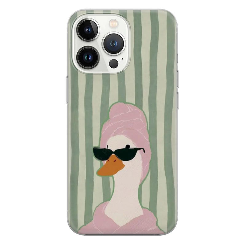 May include: A clear phone case featuring a cartoon illustration of a goose wearing sunglasses and a pink towel on its head. The background has vertical green and white stripes.