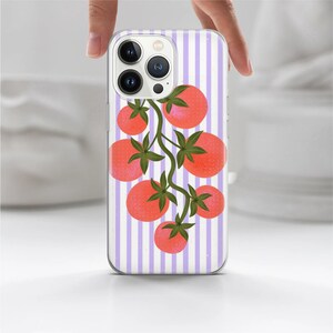 May include: A clear phone case with a purple and white striped background and a design of red tomatoes on a vine.