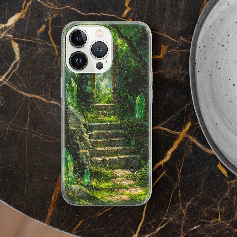 May include: A phone case with a green and brown forest scene. The case features a stone staircase leading up to a clearing in the woods. There are green crystals scattered throughout the scene.