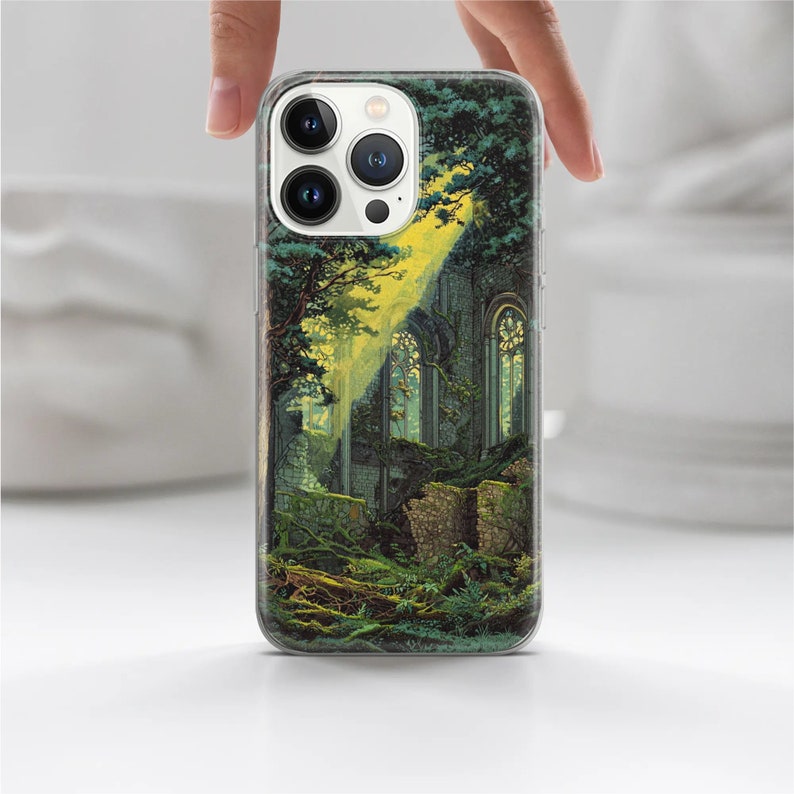 May include: A clear phone case with a colorful image of a stone building overgrown with green vines and trees. The building has large windows and a yellow glow coming from inside.