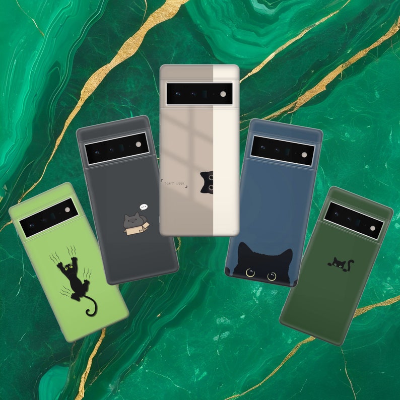 May include: Five different phone cases with black cat illustrations. The cases are in various colors, including green, blue, beige, and gray. The cases feature different cat designs, including a cat with a box, a cat with a speech bubble, a cat with its paws up, a cat with its eyes closed, and a cat with its tail curled.