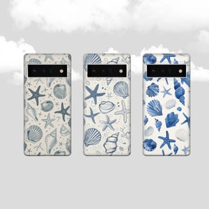 May include: Three phone cases with a beach theme. Each case features a different pattern of seashells and starfish in shades of blue and white on a cream background. The cases have a camera cutout.