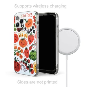 May include: A white iPhone case with a colorful illustration of various types of tomatoes. The case has a clear back and supports wireless charging. The text "MATOES" is printed on the case.