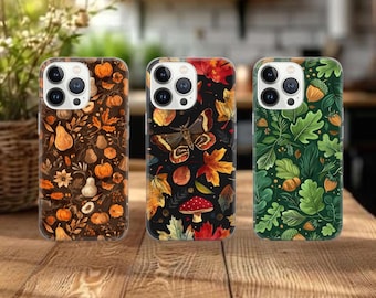 May include: Three phone cases with autumnal designs. One case features pumpkins and pears on a brown background. Another has a butterfly and leaves on black. The third case displays green leaves and acorns.