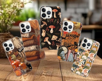 May include: Five smartphone cases featuring autumn and Halloween themes. Designs include a stack of sweaters, a black background with various mushrooms, a spooky scene with text reading 'Tis the Season to be Spooky', and a grid of small seasonal icons.