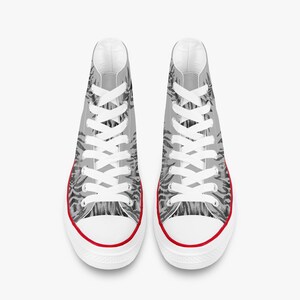 May include: Pair of high-top canvas sneakers with a gray and black pattern. The sneakers have white laces, a white sole, and a red trim around the base. The shoes are designed for casual wear.