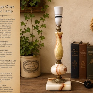 May include: Vintage onyx table lamp with a cream, amber, and honey-toned natural stone pattern. The lamp has brass details and a solid onyx base. The lamp is fully working and has a UK plug. The lamp is a perfect gift for lovers of vintage decor.