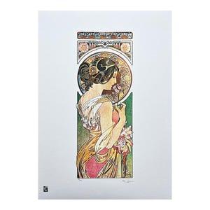 May include: Art Nouveau print depicting a woman in profile with flowers. The artwork uses gold, red, green, and cream. The woman's hair is elaborately styled, and the background features floral and geometric patterns. The print is on a white background.